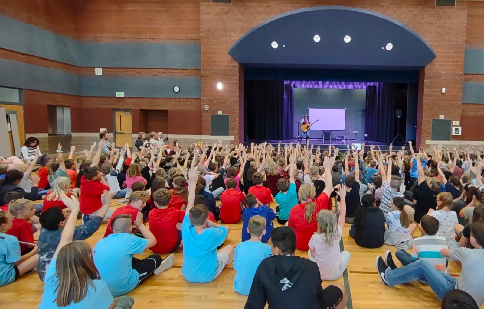 Kristen J. Lloyd presenting the Find Your Brave K-6 assembly to a Northern Utah school audience