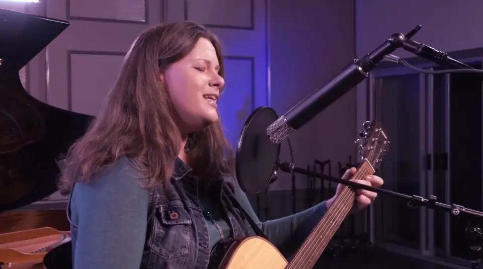 Kristen singing and playing guitar for live dinner music